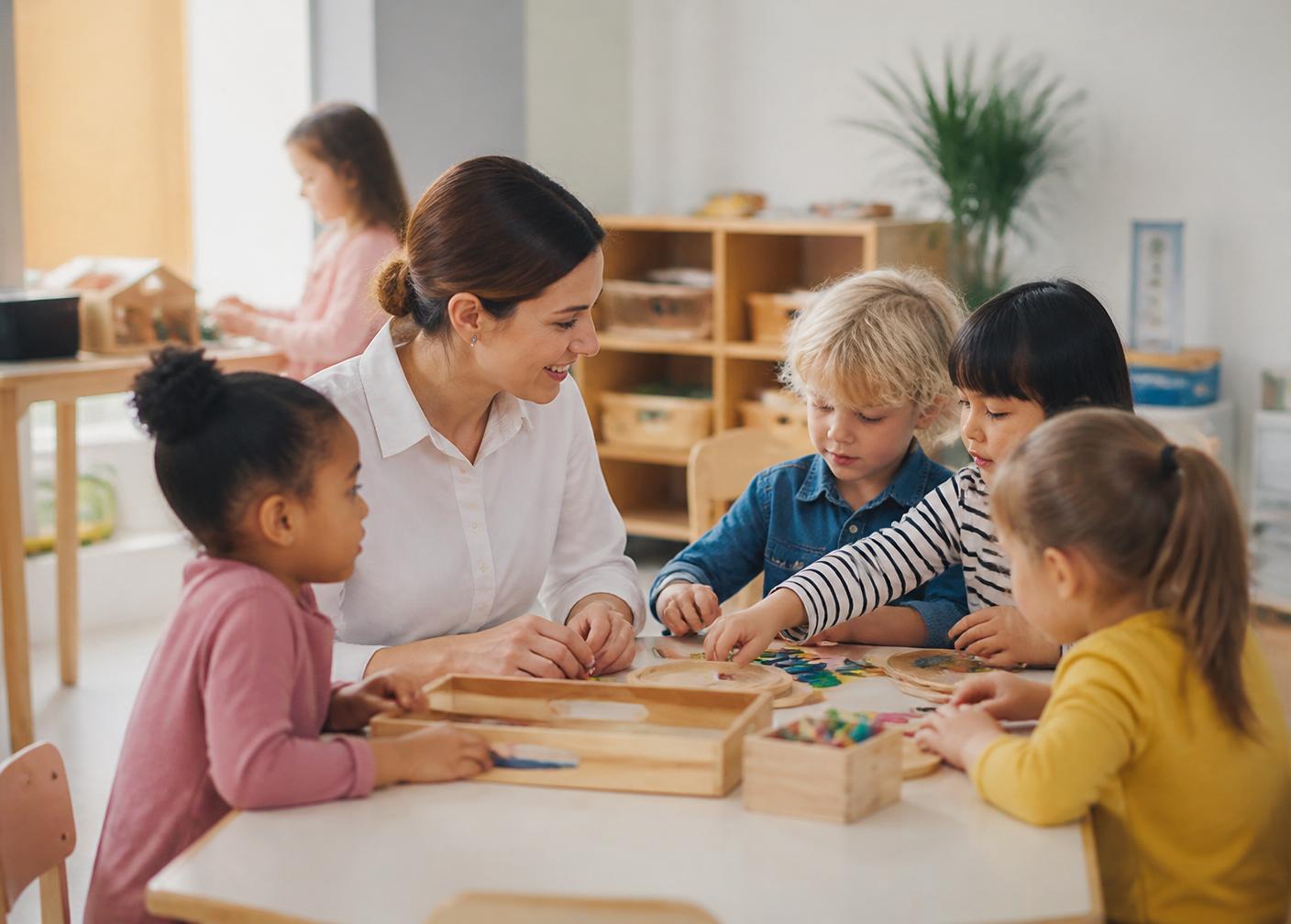 A teacher fully engaged with young children during a calm hands-on classroom activity.